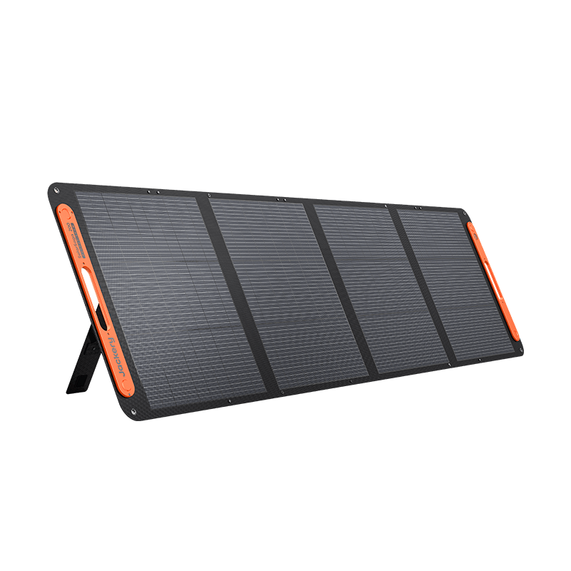 Jackery SolarSaga 200W portable solar panel, four-segment rigid-frame monocrystalline unit unfolded on its integrated rear kickstand, with orange-trimmed borders, Jackery branding along one side, and cutout carry handles on both end frames.